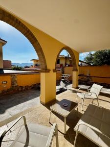 an outdoor patio with chairs and a table at Elyas Guest House in Villasimius
