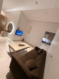 a living room with a couch and a table at NOOR iNN , Prime Location, SelfEntry in Medina