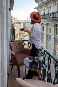 a person standing on a balcony playing a video game at Vita Suites Karaköy in Istanbul