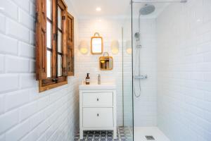 a white bathroom with a sink and a shower at Ca'n Ruquet in Campanet +29 photos