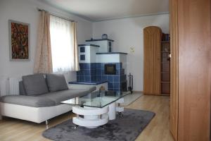 ein Wohnzimmer mit einem Sofa und einem Glastisch in der Unterkunft Haus zum Wohlfühlen in Wien