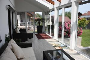 a screened in porch with a couch and some flowers at Haus zum Wohlfühlen in Vienna