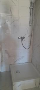 a bathroom with a shower with a glass door at ELA Apartmani i sobe in Neum +13 photos