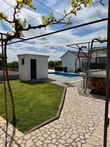 a backyard with a swimming pool and a house at Residence Stina in Široki Brijeg