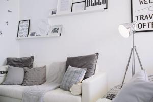 a white living room with a couch and a lamp at Studio Apartment By Travel Lets Holiday Homes Lagada With Pool in Makry Gialos