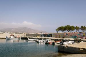 a group of boats docked in a body of water at Studio Apartment By Travel Lets Holiday Homes Lagada With Pool in Makry Gialos