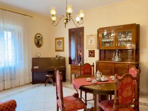 a dining room with a table and a piano at Suite Apartment Mandorlo in Volterra