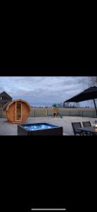 a small wooden house with a swimming pool and a playground at Domek BrzozoweLove in Szczodrowo