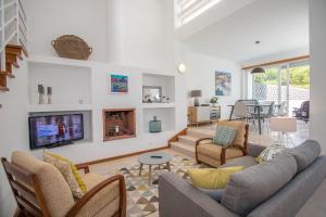 a living room with a couch and a tv at Villa Granada by Algarve Holidays in Almancil