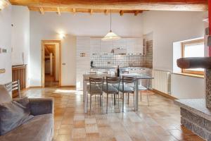 a kitchen with a table and chairs in a room at Baita Del Canton in Valdidentro