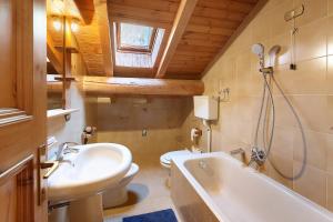a bathroom with a sink and a tub and a toilet at Baita Del Canton in Valdidentro +95 photos