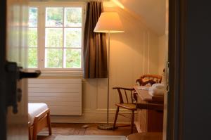 a bedroom with a desk and a lamp and a window at Gasthaus Rössli in Trogen
