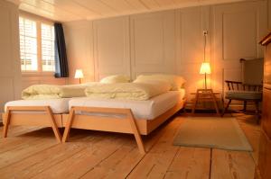 a bedroom with a bed and a table in it at Gasthaus Rössli in Trogen