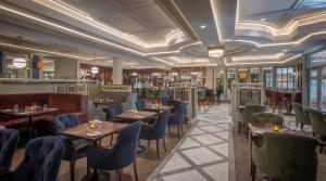 a rendering of a restaurant with tables and chairs at Hotel Kilmore in Cavan