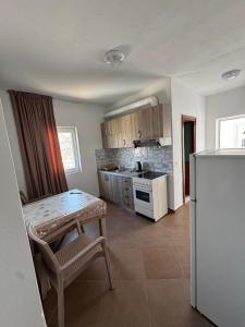 a kitchen with a table and a stove top oven at Redi's Seaview Apartments in Sarandë +54 photos