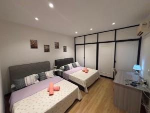 a bedroom with two beds and a couch at Roxy Apartment Kuching in Kuching +26 photos