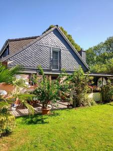 a house with a yard with plants at Haus Sielblick in Wangerland