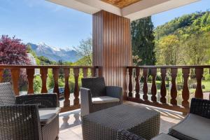 a balcony with chairs and a view of mountains at Maison L'arrieulat in Argelès-Gazost