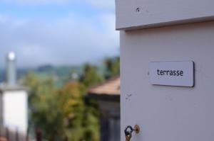 a sign on the side of a white building with the word teenager at Gasthaus Rössli in Trogen