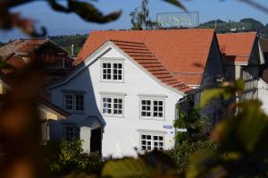 a white house with a red roof at Gasthaus Rössli in Trogen