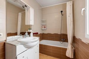 a bathroom with a sink and a bath tub at Casacuéntame in Granada +24 photos