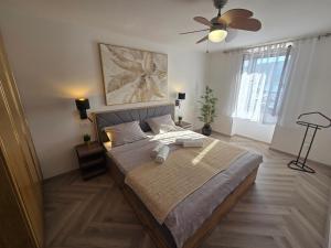 a bedroom with a bed and a ceiling fan at Apartment Borna in Baška