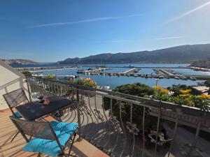 a balcony with chairs and a view of a marina at Apartment Borna in Baška