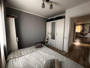 a bedroom with a bed and a room with a closet at Cabanuta in Brașov in Braşov