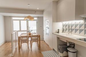 a kitchen with a table and two chairs in a kitchen at Lumen Mare Malvarrosa by SH Hoteles in Valencia