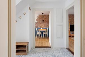 a dining room with a table and a brick wall at Feierabend am Kaiserstuhl in Bötzingen