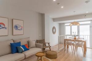 a living room with a couch and a table at Lumen Mare Malvarrosa by SH Hoteles in Valencia