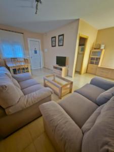 a large living room with couches and a television at MEDDAYS Villa BERLÍN in Miami Platja