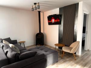 a living room with a couch and a stove at Cabanuta in Brașov in Braşov +21 photos
