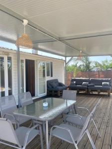 a patio with a table and chairs and a couch at El Palmar Paradise in El Palmar