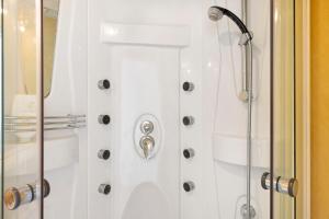 a bathroom with a shower with a glass door at Chambre d'hôtes Les Loges in Luçon +18 photos