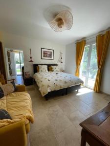 a bedroom with a bed and a couch at L isaro in Anthé +18 photos