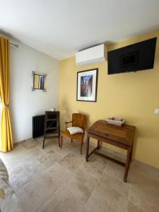 a living room with a table and a chair at L isaro in Anthé