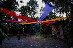 a group of colorful flags are hanging in a yard at CoffeeLand in Padinjarathara