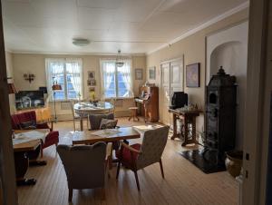 a living room with a table and chairs at Granum Gård in Fluberg