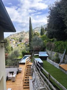 a wooden deck with a view of a garden at Hotel Paradiso Conca d'Oro in Nago-Torbole