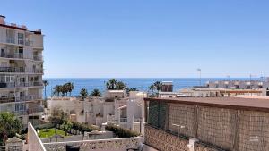 a view of the ocean from a building at Casa Playa Torrecilla by South Costa in Nerja