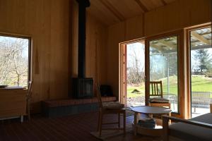 a living room with a fireplace and a table and chairs at Østhusvik Cabin in Stavanger