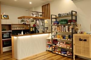 a kitchen with a counter and shelves of food at 宿時代民宿 24H 自助入住 入住前需完成線上報到 Hometime Self Check-in in Dayuan