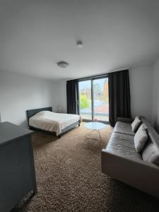 a bedroom with a couch and a bed and a window at Villa in Meisenheim
