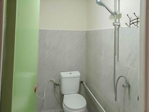 a bathroom with a toilet and a shower at Verisha Inn Singkawang RedPartner in Singkawang