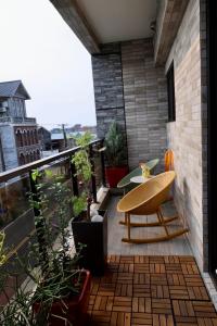 a balcony with a chair and a table on a building at 宿時代民宿 24H 自助入住 入住前需完成線上報到 Hometime Self Check-in in Dayuan