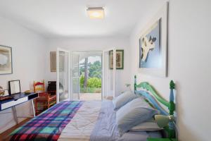 a bedroom with a bed and a desk at Puigvermell in Pals +20 photos