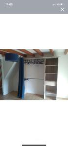 a loft bed in a room with a ladder at Maison à proximité des plages in Bénodet +4 photos