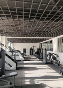 a gym with treadmills and elliptical machines at Little Haven Stays-Near UN & Two Rivers in Ruaka