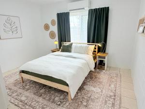 a bedroom with a bed and a window at 'Your Place on Davidson' Uno in Mount Isa